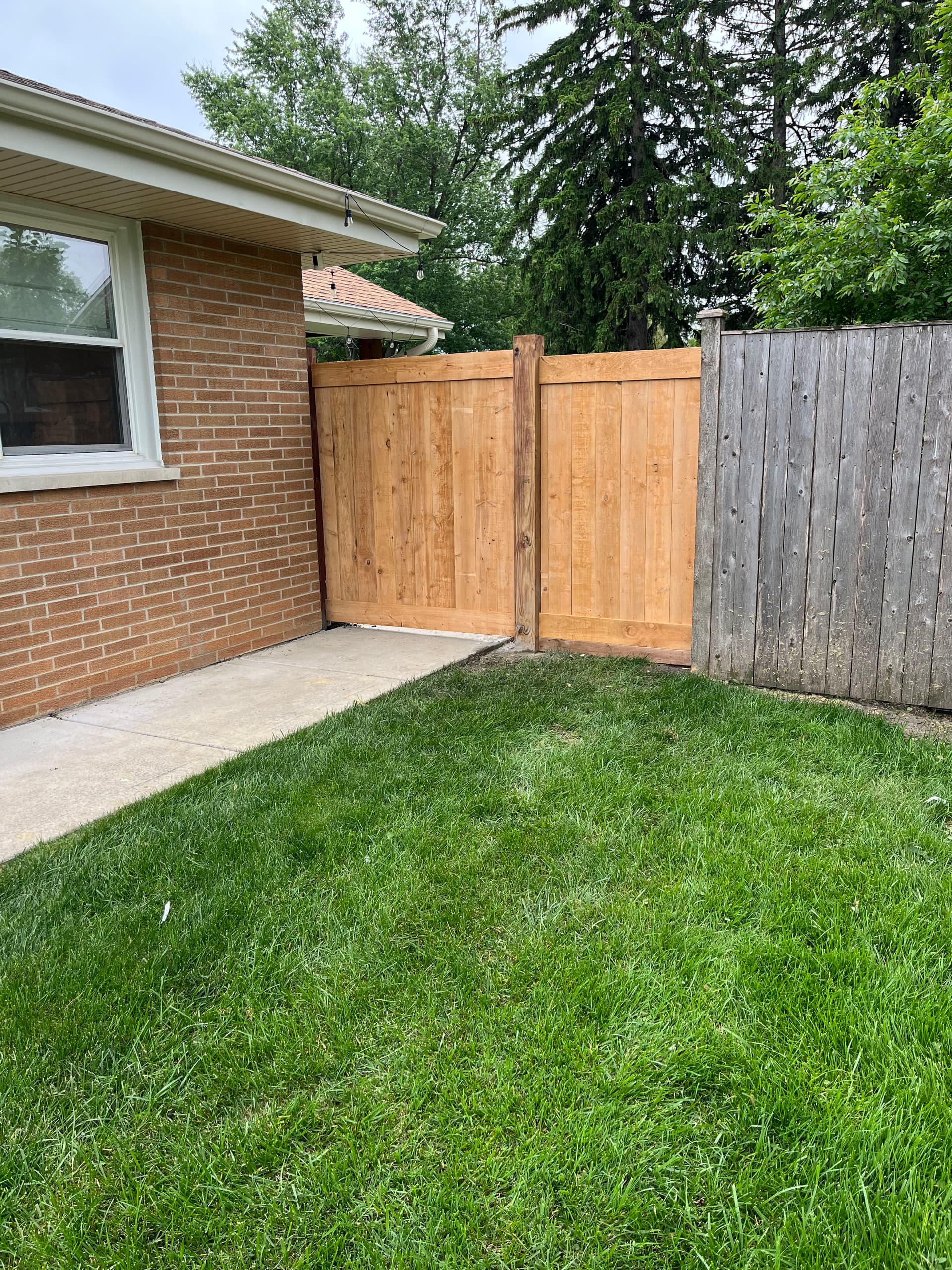 Privacy Fence Build with a Hidden Gate That Disappears Into the Design